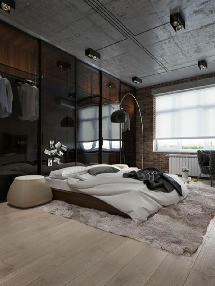 fachadas-modernas-dormitorio-tonos-oscuros-lámpara-de-diseño-alfombra-grande-suelo-de-madera