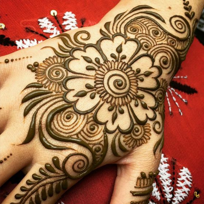 tatuaje-henna-para-mujer-en-la-mano-flores-henna-marrón