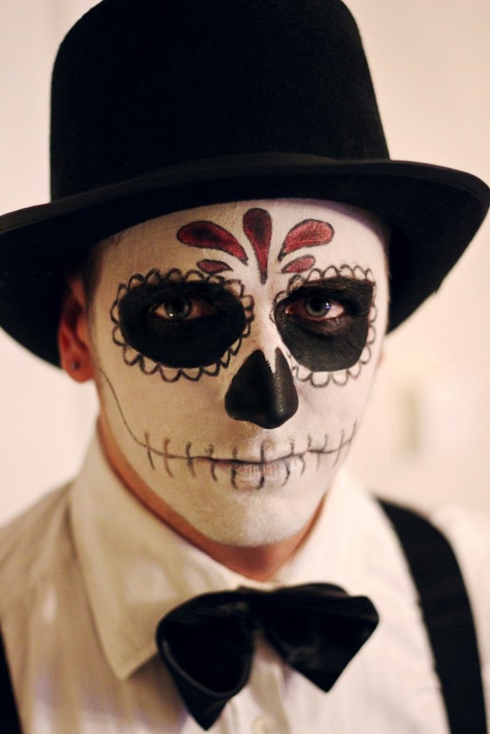 maquillaje halloween hombre, hombre maquillado como calavera mexicana con traje y gorro