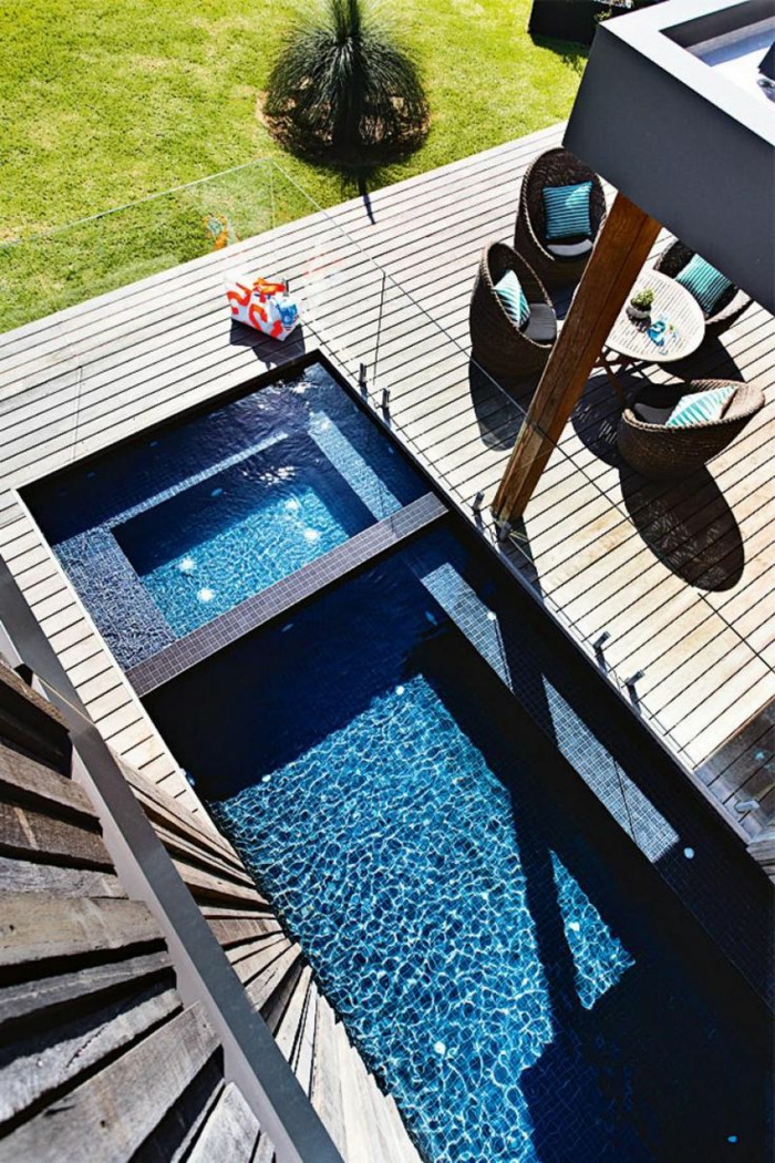 construcción de piscinas, patio con piscina pequeña fotografiado desde lo alto, mesa con sillas de rattan, suelo de tarima