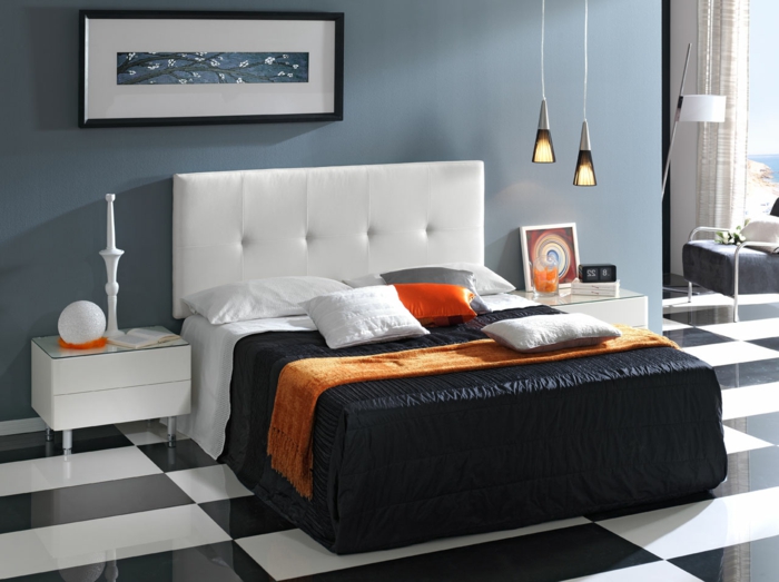 cabeceros originales, dormitorio moderno con paredes en azul, cuadro minimalista y cama funcional blanca con cabecero de piel, suelo con azulejos de mármol