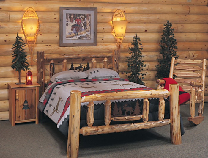 cabañas rurales, dormitorio acogedor con cama hecha de leña, cobijas con motivos invernales, pinos decorativos