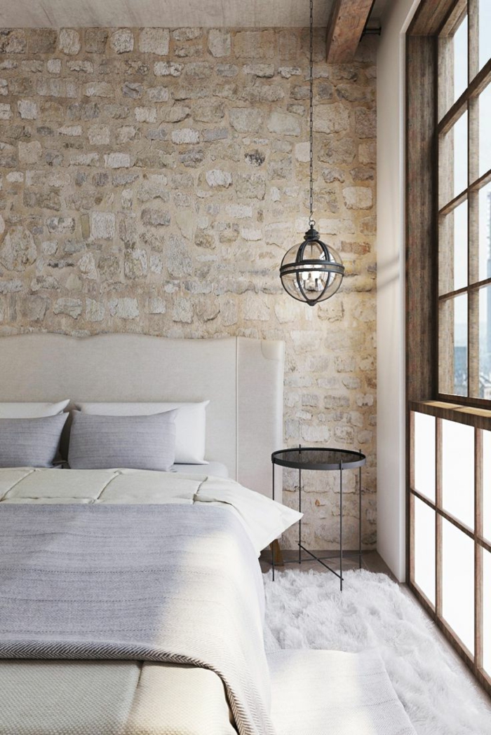 paredes decoradas, dormitorio rústico con cama doble, lámpara colgante y ventana grande, pared de piedra rústica
