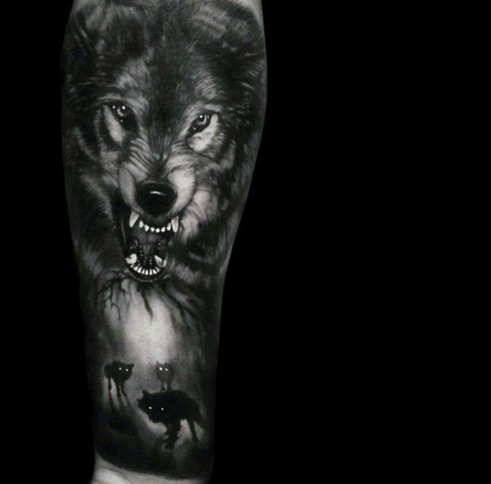 tatuajes de lobos, tatuaje en negro solido para el antebrazo, manada de lobos pequeños, cabeza grande de lobo atacando