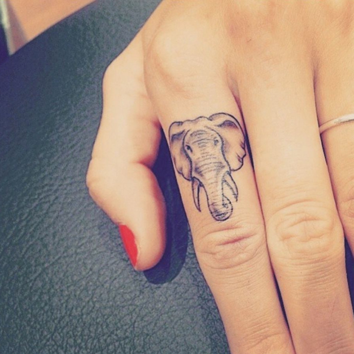 tatuaje corazon, tatuaje pequeño para mujer, cabeza de elefante en el índice, anillo de plata, esmalte rojo