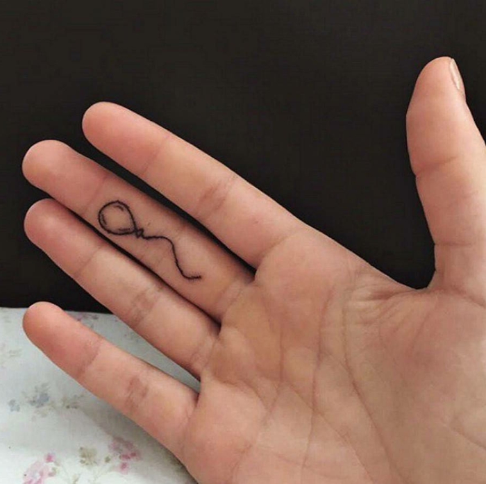 ideas para tatuajes, tatuaje divertido en el dedo medio, globo pequeño en la cara anterior del dedo