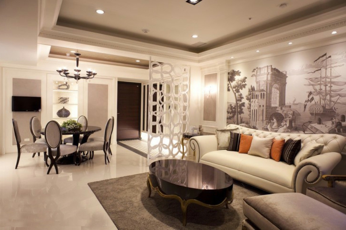 separadores de ambientes, grande salón con comedor, divisor de espacios original, paredes en beige con vinilos decorativos y mesa vintage