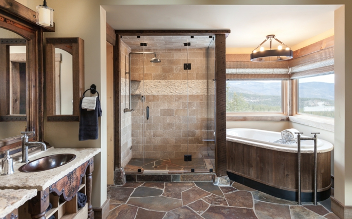 baño rustico con vista, azulejos en el suelo y las paredes y muebles de madera oscura, lavabos rusticos y estanterias para baños 