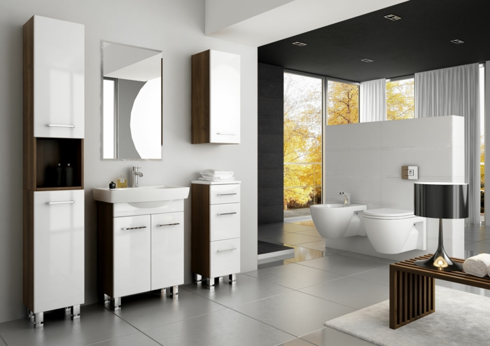 estilo riguroso moderno, decoración en blanco y marrón, mueble lavabo, armarios con patas, ventanales, mesita con lámpara, suelo de baldosas