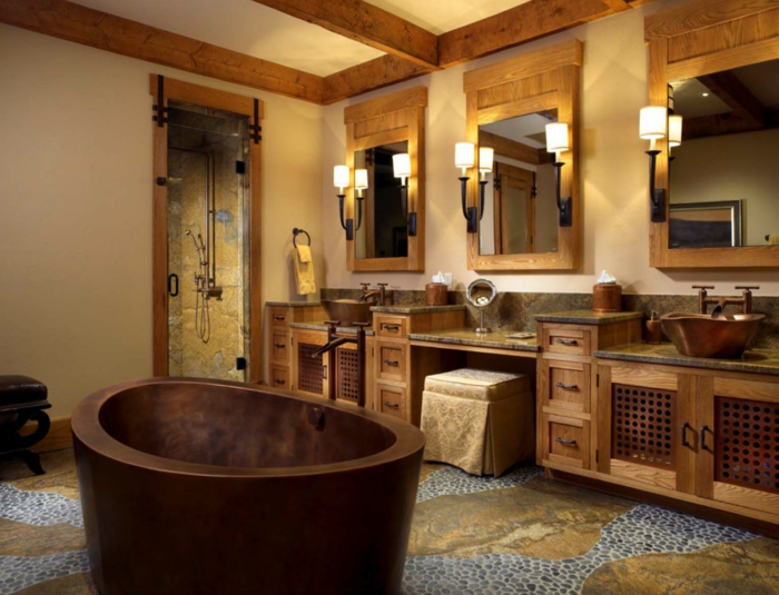decoración baño rústico moderno, muebles auxiliares, lavabo doble y tocador, madera y piedra, espejos enmarcados, bañera èqueña redondeada