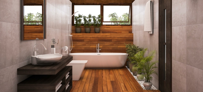 bañera moderna exenta y armarios modernos, azulejos para baños en las paredes, techo revestido de parquet y decoración de plantas verdes