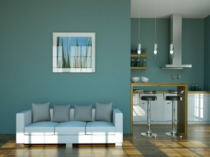 salon moderno, estilo minimalista, cocina abvbierta al salon, barra de madera, pared en gris azulado, sofá blanca con cojines gris