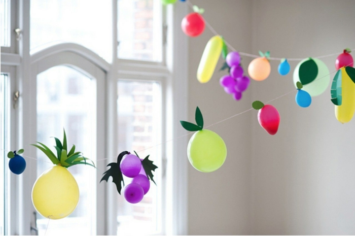decoracion con globos de diferente tamaño y color, globos en forma de frutas, guirnalda DIY para decorar la casa 