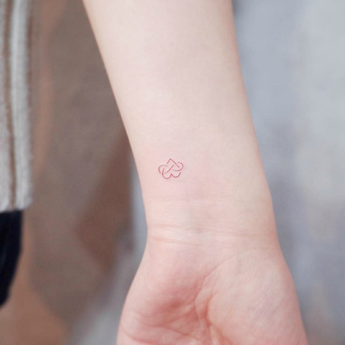 ejemplo de un tatuaje minimalista en la forma de corazón con pequeño detalle, tatuajes antebrazo mujer originales 