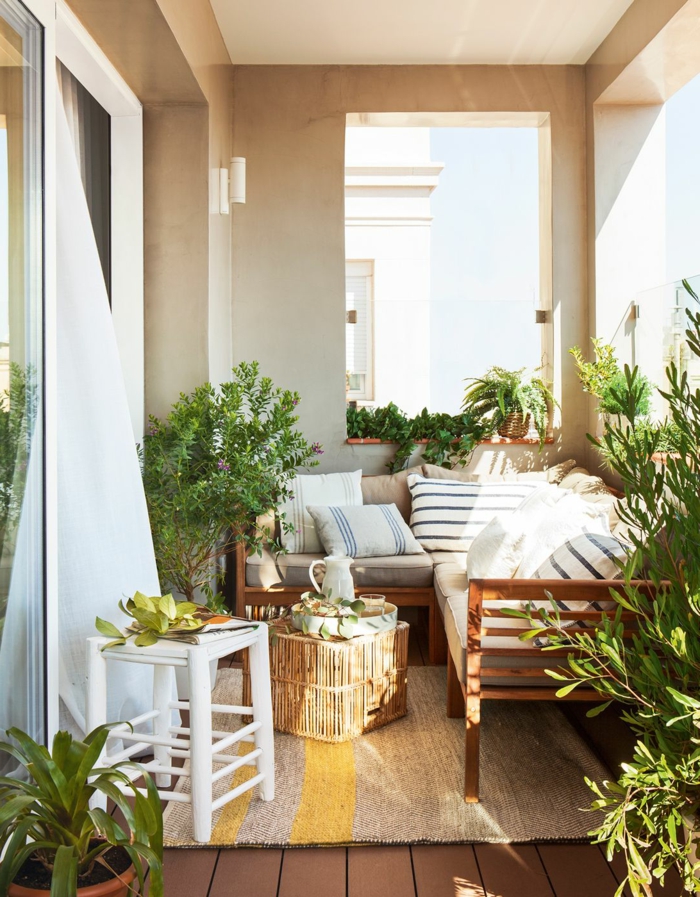 terraza decorada en estilo bohemio con muebles de madera y mimbre y muchas plantas verdes, ideas decoracion terrazas pequeñas