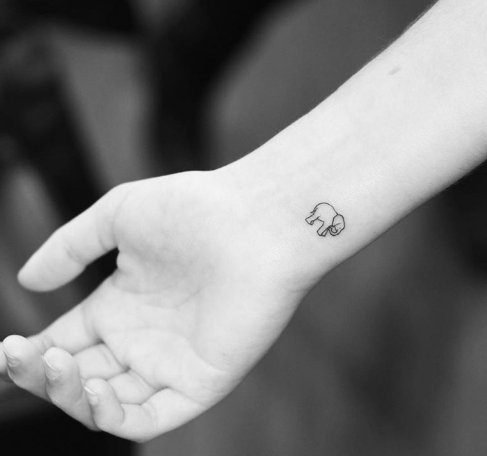 tatuajes minimalistas con significado, tatuajes simbolicos en la muñeca, pequeño elefante tinte negro 