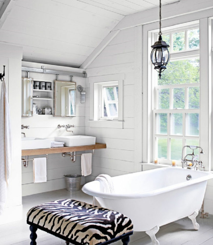 diseño de baños blanco y negro en estilo ecléctico, bañera exenta patas garra y banco tapizado estampado animal 