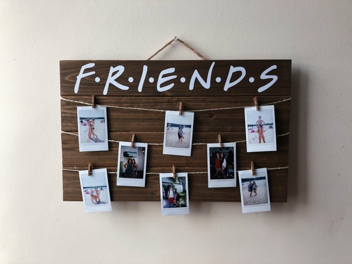 que le puedo regalar a mi mejor amiga, cartel de madera con cuerdas y fotos colgadas en el con pinzas de madera