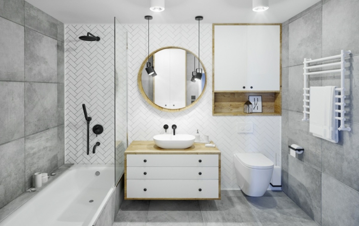 baños grises modernos decorados en estilo contemporáneo, espejo moderno con forma oval, baldosas grises 