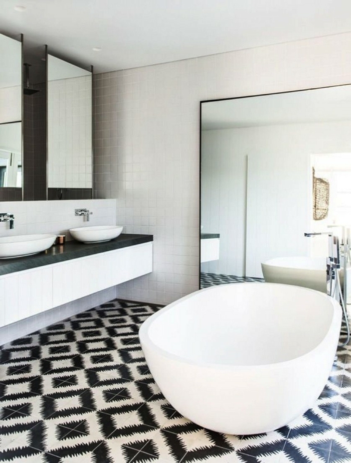 azulejos de baño, suelo de azulejos de figuras en blanco y negro, espejo grande en una pared, lavabos blancos