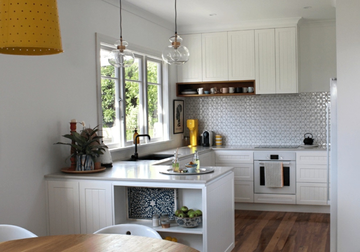 pequeña cocina decorada en blanco con azulejos modernos y suelo de parquet, cocina blanca y gris 