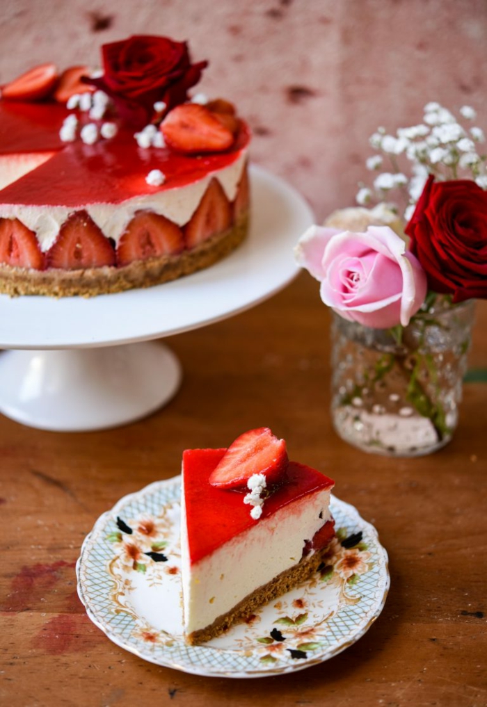 postres ricos decorados con encanto, tarta de queso con fresas y glaseado rojo, decoración con flores 