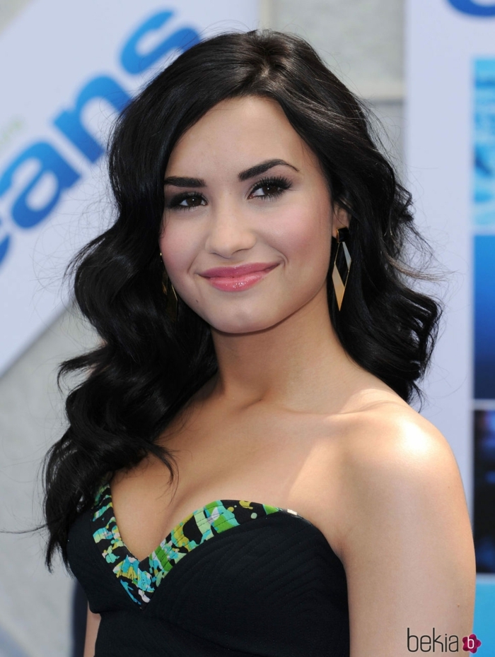 peinado ondas al agua, Demi Lovato con la melena larga negra con labial gloss transparente, vestido