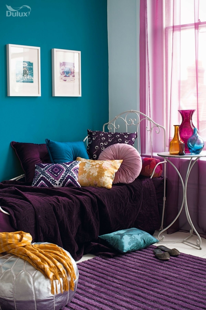 pisos modernos, paredes en azul oscuro, alfombra en color morado, sofa con cojines de colores