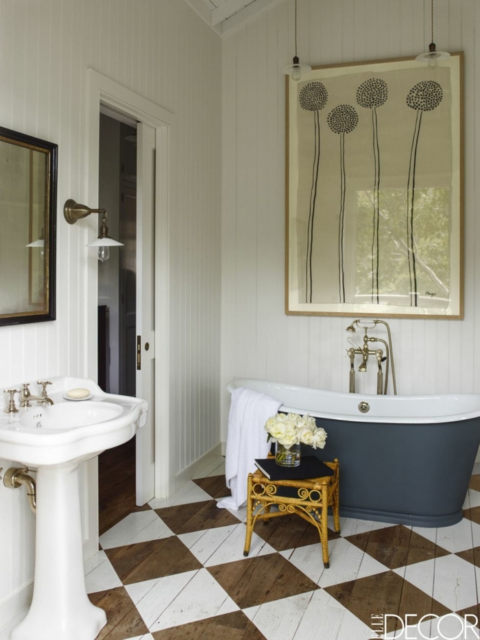 precioso baño decorado en colores claros estilo vintage, paredes en blanco, bañera de diseño y grande pintura en la pared 