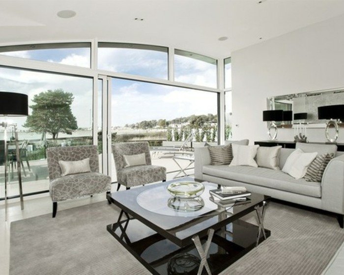 grande salón con muebles en gris, habitacion gris con grandes ventanales, preciosos elementos arquitectónicos