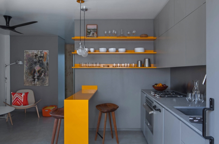 combinaciones de colores bonitas para cocinas pequeñas con isla, paredes y suelo en gris isla en color naranja 