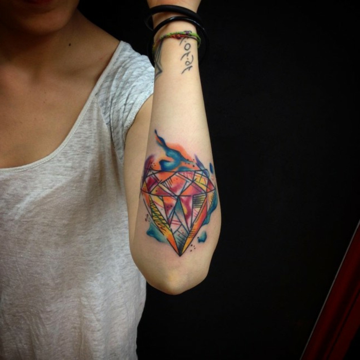 precioso diseño de tatuaje en el antebrazo, tatuaje diamante colorido, ideas de tatuajes acuarela con significado 