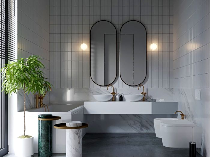 espacios decorados en estilo contemporáneo, baño en blanco y gris con dos espejos modernos de forma original y plantas verdes 