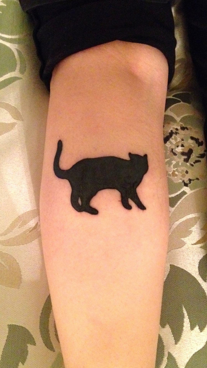 simbologia del gato negro, ideas de tatuajes con silueta de gato, tatuaje en el antebrazo con bonito gato en color negro 