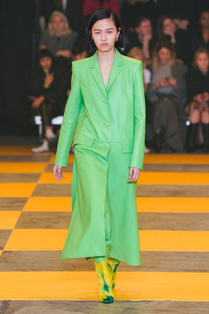 colores en tendencia para un outfit invierno moderno, abrigo largo en color verde neón con botas en amarillo y verde