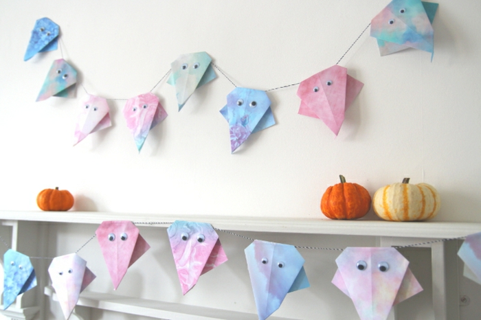 adornos halloween caseros para decorar la casa, guirnalda de papel con fantasmas en colores pastel, tutoriales de manualidades fáciles y rápidas 