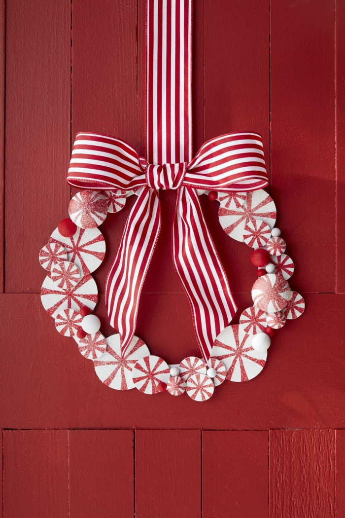 puerta pintada en rojo adornada con una corona DIY en blanco y rojo, decoracion navideña 2019 en fotos bonitas 