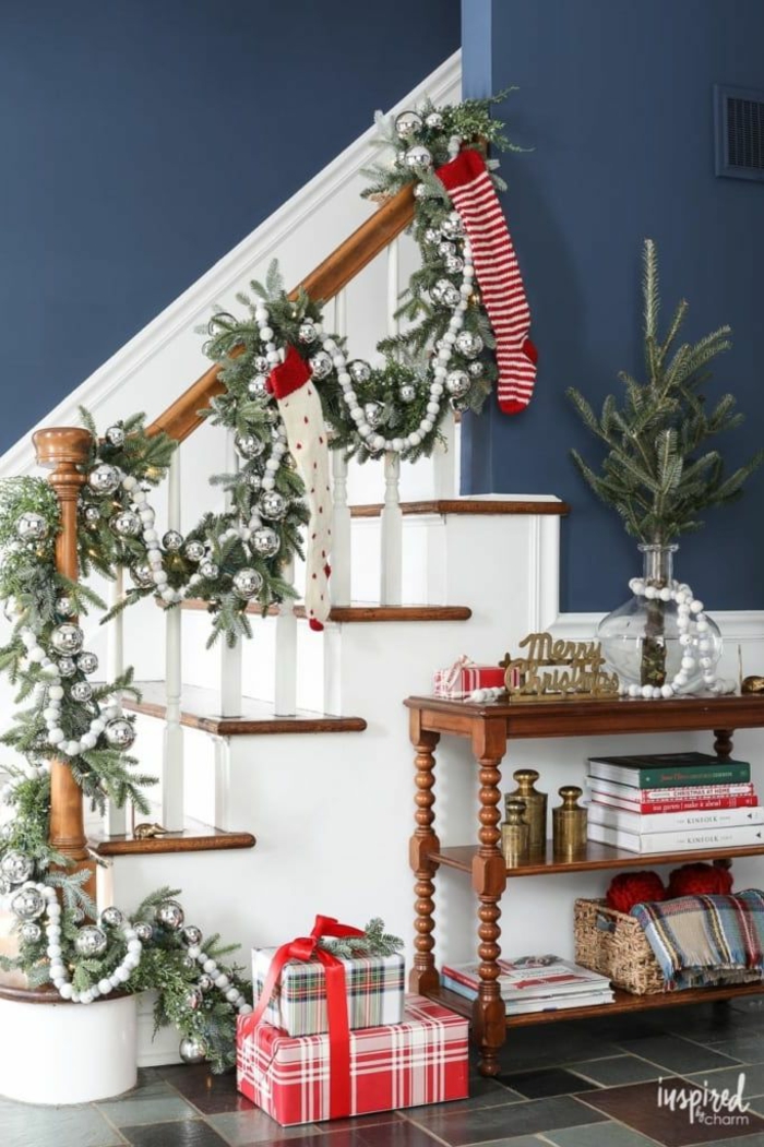 escaleras decoradas con guirnaldas verdes con adornos en color plateado, casas acogedoras decoradas para navidad 