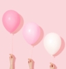 tres globos rosas sobre fondo rosa