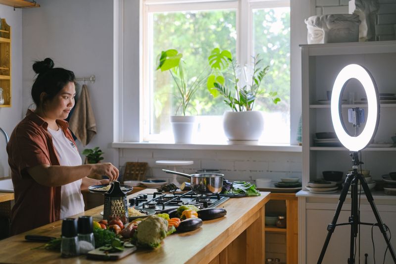 mujer que cocina en la cocina y foto vlog